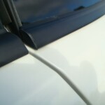 Before and after photographs of a damaged white Subaru that was repaired by Elite Paint & Body Shop in West Palm Beach, Florida